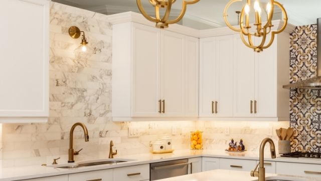 Wall sconce above a sink in a small kitchen