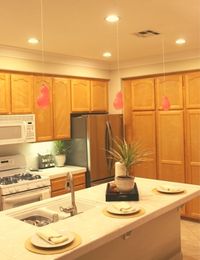 Using balloons to visualize how kitchen pendant lighting will look in a kitchen.